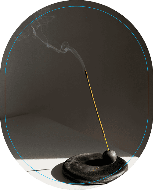 Burning incense stick with rising smoke