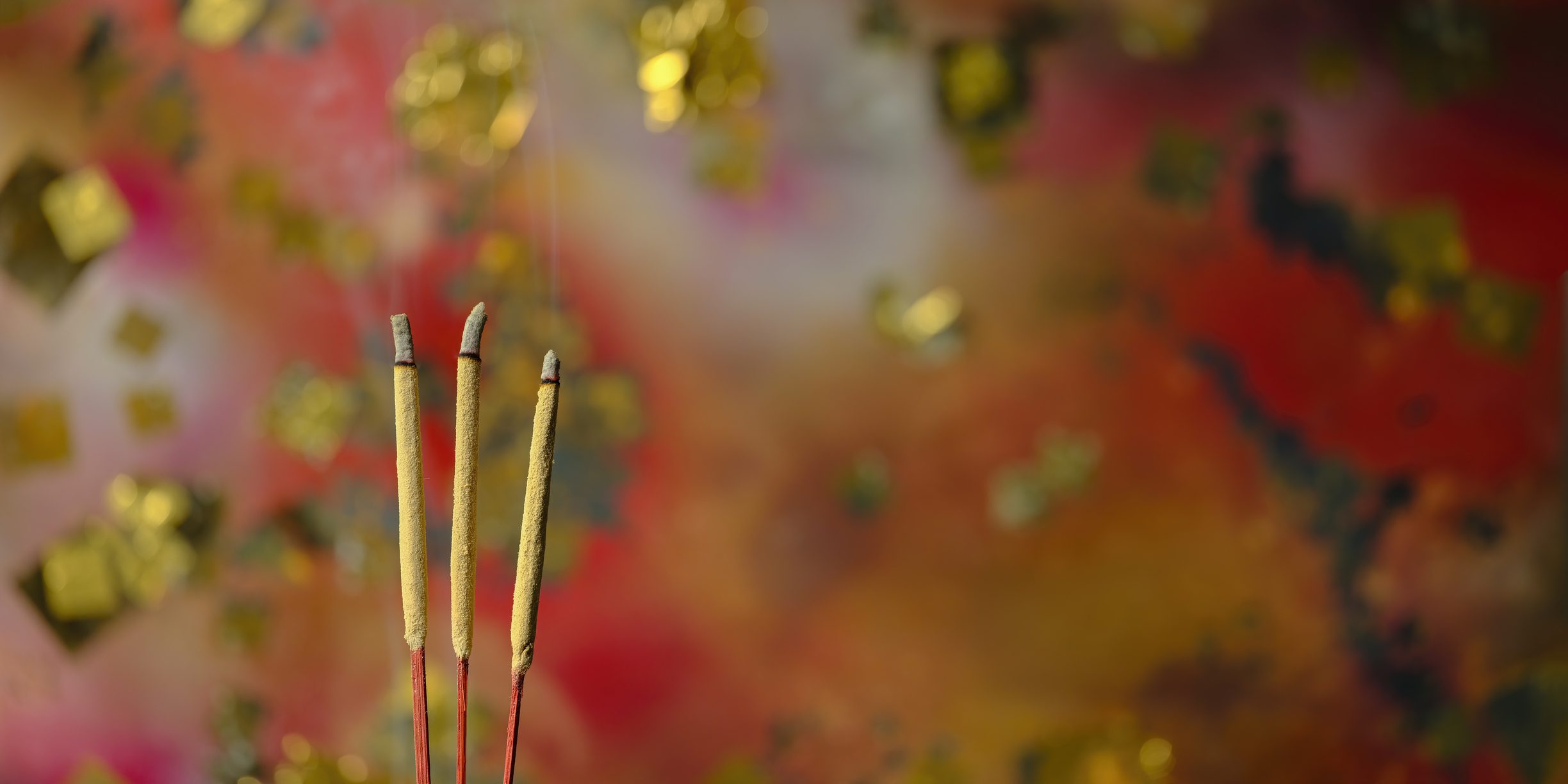Incense sticks with vibrant blurred background
